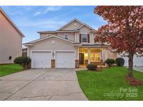 Charming two-story home featuring a two-car garage, well-manicured lawn, and inviting front porch at 6635 Ruth Ferrell Ct, Charlotte, NC 28269
