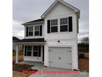 Charming two-story home featuring white siding, black shutters, and an attached one-car garage at 803 Jost St, Statesville, NC 28677