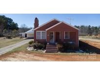 Charming brick home featuring a cozy front porch and well-maintained landscaping at 850 Dunns Mountain Church Rd # 1, Salisbury, NC 28146