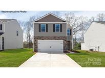 Two-story home featuring a two-car garage and a stone and gray siding exterior at 878 Two Brothers Ln, York, SC 29745