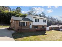 Charming two-story home with brick accents, black shutters, and a well-maintained front yard at 108 Donna Ave, Gastonia, NC 28052