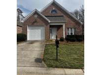 Charming brick home featuring a well-maintained lawn, attached garage, and inviting front entrance at 1229 Mcgill Pond Ln, Rock Hill, SC 29732