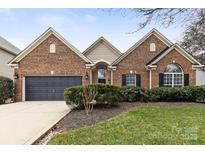 Charming brick home with a well-manicured lawn and a two-car garage at 12430 Kemerton Ln # 17, Huntersville, NC 28078