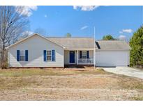 Charming single-story home with blue shutters, front porch, and attached two car garage at 1345 Beagle Run, Salisbury, NC 28146