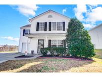 Charming two-story home with a well-maintained front yard and a bright white exterior at 1614 Harland St, Charlotte, NC 28216