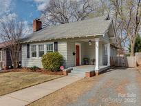 Charming single-story home with a cozy front porch, red door, and well-maintained landscaping at 324 Westwood Ave, Charlotte, NC 28203