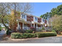 Charming brick townhome with a welcoming front porch, manicured landscaping, and inviting curb appeal at 4860 S Hill View Dr, Charlotte, NC 28210