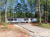 Charming single-story home with newly installed driveway, surrounded by mature trees at 635 Acre Ct, York, SC 29745