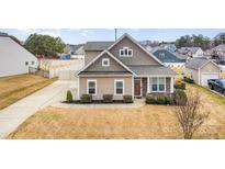 Charming single-Gathering home with a well-manicured lawn and a cozy, inviting front porch at 7413 Adirondack Dr, Denver, NC 28037