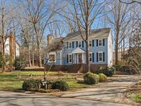 Charming two-story home with blue siding, blue shutters and well-maintained landscaping at 9601 Whitethorn Dr, Charlotte, NC 28277