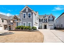 Two-story home featuring a well-manicured lawn and an attached two-car garage at 982 Old Trace Nw Rd, Concord, NC 28027