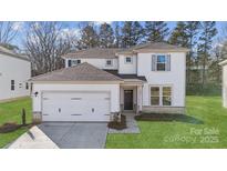 Charming two-story home featuring a two car garage and inviting front yard at 9928 Manor Vista Trl, Kannapolis, NC 28027