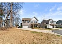 Charming two-story home featuring a well-manicured lawn and inviting front porch at 1036 Bramcote Ln, Charlotte, NC 28215