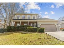 Charming two-story home with a well-manicured lawn and a covered front porch, inviting you to relax and enjoy the outdoors at 11834 Mallard Ridge Dr, Charlotte, NC 28269