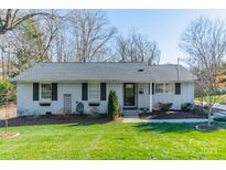 Charming one-story home features a well-manicured front yard and classic brick exterior at 1310 Seneca Pl, Charlotte, NC 28209