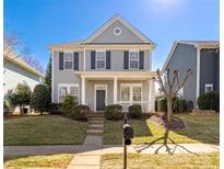 Charming two-story home with a welcoming front porch and well-manicured lawn at 17818 Overland Forest Dr, Cornelius, NC 28031