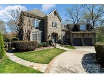 Stunning stone and stucco exterior with a well-manicured lawn and two-car garage, exuding curb appeal at 2209 Vauxhall Ct, Charlotte, NC 28226