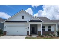 Charming single-story home featuring a two-car garage and inviting front porch at 407 Sunharvest Ln, Indian Trail, NC 28079