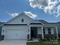 Charming single-story home with white siding, black accents, and an attached two-car garage at 407 Sunharvest Ln, Indian Trail, NC 28079