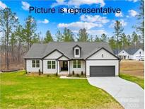 Charming new construction home featuring a modern design, neutral palette, and an attached two-car garage at 8051 Smooth Stone Ct, Clover, SC 29710