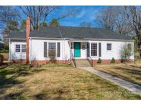 Charming single-story home featuring a brick foundation, teal front door, and manicured lawn at 904 Maple Ave, Salisbury, NC 28144