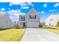 Charming two-story home with a light gray exterior, a spacious two-car garage, and a well-maintained lawn at 120 Gray Hawk Dr, Rockwell, NC 28138
