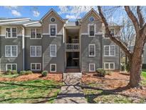 Charming condo with a well-maintained exterior, landscaped grounds, and inviting entrance at 19827 Henderson Rd # L, Cornelius, NC 28031