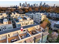 Relax on this rooftop deck with lounge seating, dining area, and gorgeous city views at 231 Uptown West Dr, Charlotte, NC 28208