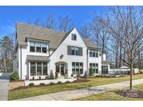Elegant two-story home with white brick, professionally landscaped yard, and welcoming front entrance at 2509 Montrose Ct, Charlotte, NC 28207