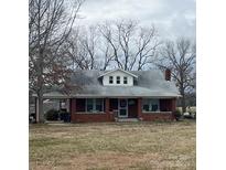 Charming brick home with a covered porch and well-maintained front yard, surrounded by mature trees at 3423 Crowder Ridge Rd, Shelby, NC 28150