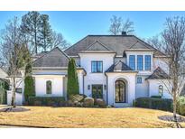 Stunning white brick home featuring a symmetrical design and a well-manicured front lawn at 4018 St Germaine Ln, Charlotte, NC 28210