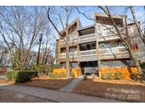 Condominium complex with gray siding, orange accents and multiple balconies at 434 W 8Th St, Charlotte, NC 28202