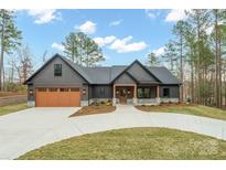 Stunning exterior of a modern home with a large driveway, two-car garage, and beautiful landscaping at 4890 Rio De Luna None, Hickory, NC 28601