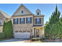 Charming two-story brick home with a well-manicured lawn, attached garage, and inviting front entrance at 503 Dixter Ln, Charlotte, NC 28211