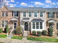 Charming townhome features a welcoming entrance and well-maintained landscaping under a bright sky at 6846 Colonial Garden Dr, Huntersville, NC 28078