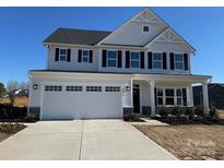 Charming two-story home with a two-car garage and black shutter accents at 1014 Bramble Hedge Rd # 3233, Indian Trail, NC 28079