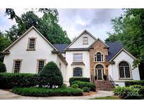 Charming home features a stone entryway, arched window and lush, manicured landscaping at 1025 Seminole Dr, Waxhaw, NC 28173