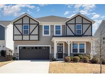 Charming two-story home with neutral siding, black trim, covered porch, and a well-maintained lawn at 19113 Hawk Haven Ln, Charlotte, NC 28278