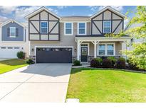Charming two-story home featuring a well-maintained lawn, a two-car garage, and stone accents at 19113 Hawk Haven Ln, Charlotte, NC 28278