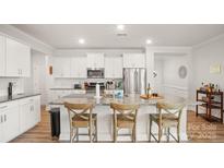Bright kitchen featuring an island with seating, granite countertops, and stainless steel appliances at 3878 Fairlady Ln, Fort Mill, SC 29707
