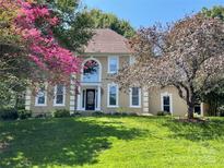 Charming two-story home featuring a well-manicured lawn and colorful landscaping at 4825 1St Street Nw Ct, Hickory, NC 28601