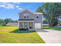 Charming two-story home with well-maintained lawn, driveway and an attached one car garage at 509 Holly St, Statesville, NC 28677