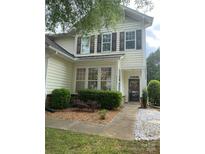 Charming two-story home with lovely landscaping and a welcoming front porch with decorative shutters at 5963 Pale Moss Ln, Charlotte, NC 28269