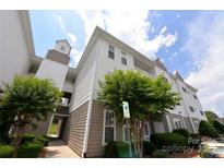 A low angle captures the building's facade with neutral siding and well maintained landscaping at 10125 Westmoreland Rd, Cornelius, NC 28031