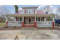 Charming home featuring a welcoming front porch and a well-maintained yard, creating inviting curb appeal at 1386 Jennings Rd, Statesville, NC 28625