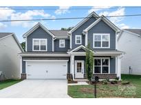 Charming two-story home features a well-manicured lawn, inviting curb appeal, and a classic architectural style at 1809 Country Club Rd, Lincolnton, NC 10757