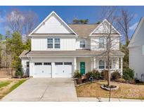 Charming two-story home with a two-car garage, landscaped yard, and inviting front porch at 2076 Brightflower Ln, York, SC 29745