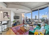 Chic living room featuring floor-to-ceiling windows showcasing stunning city views at 210 N Church St # 1413, Charlotte, NC 28202