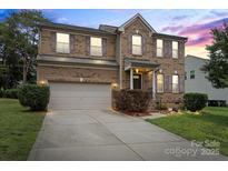 Charming two-story brick home with attached garage, landscaped yard and inviting front entrance at 2177 Galloway Sw Ln, Concord, NC 28025