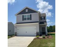 Charming two-story home with a two-car garage, light gray siding, and a well-manicured lawn at 3418 Saddlebred Dr, Gastonia, NC 28052